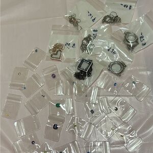 Glass and cage charm holders with semi-precious gems